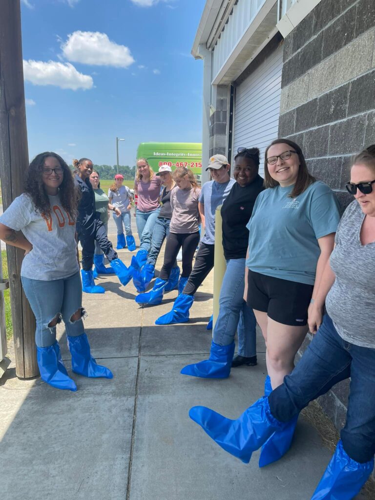 2023 Cohort showing off their covered blue feet