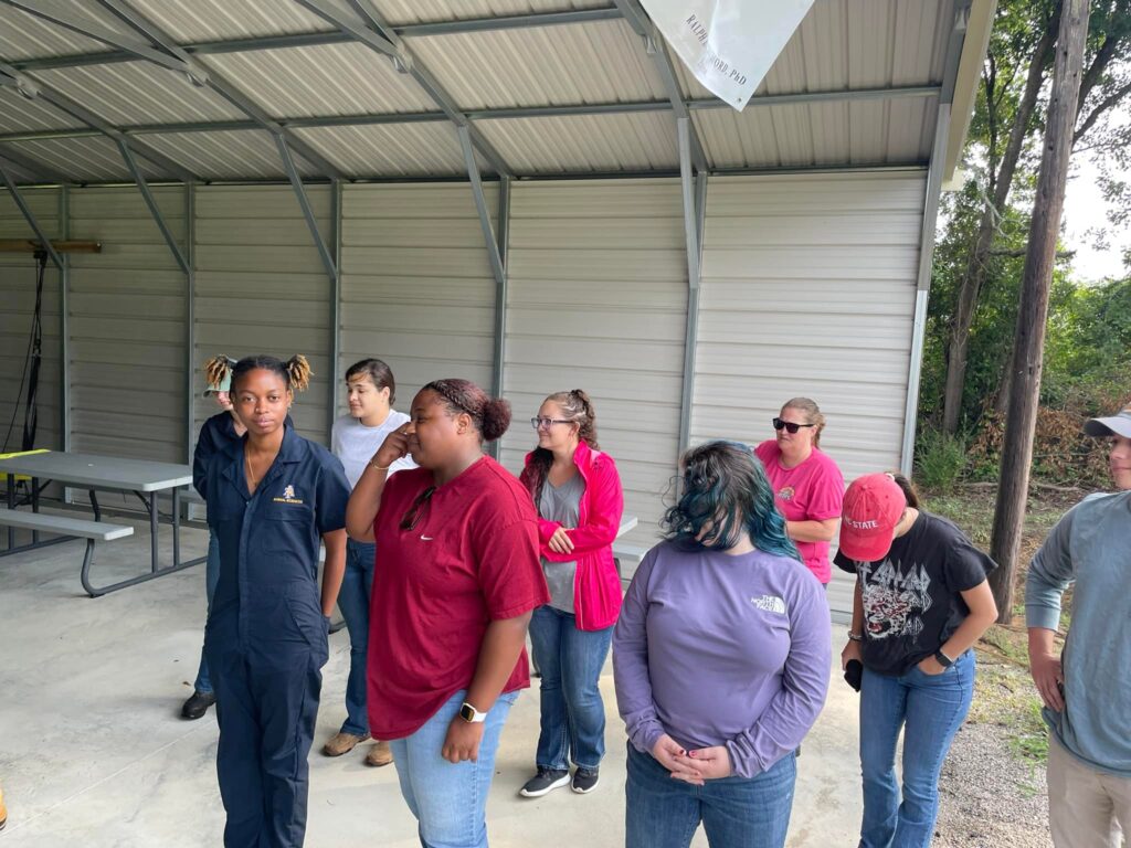 2023 Cohort standing in outdoor building