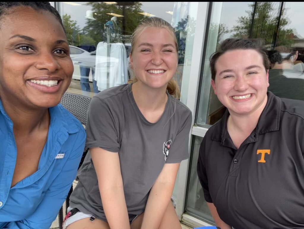 Three women smiling for the camera
