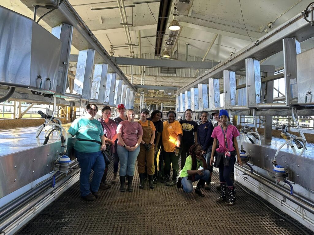 2024 Cohort standing in a procesing center