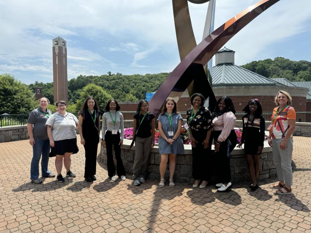 2024 Cohort posing in front of a sculpture
