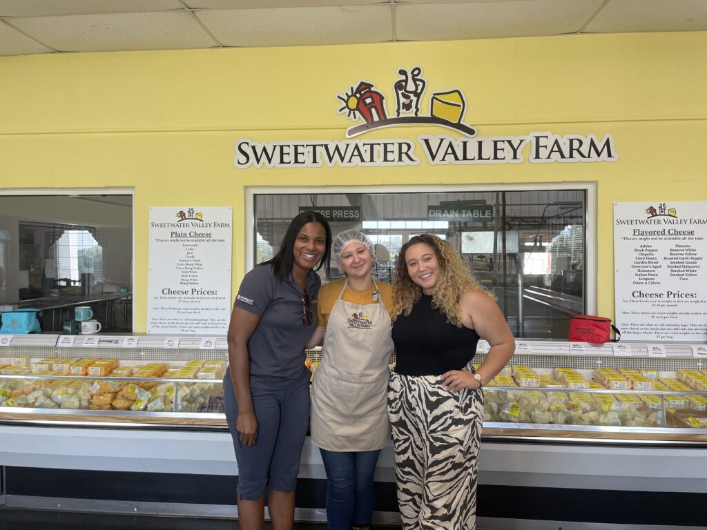 3 people standing in front of cooler at Sweetwater Valley Farm