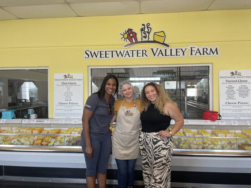 3 people standing in front of a cooler at Sweetwater Valley Farm