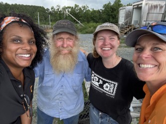 four faculty members posing together outside