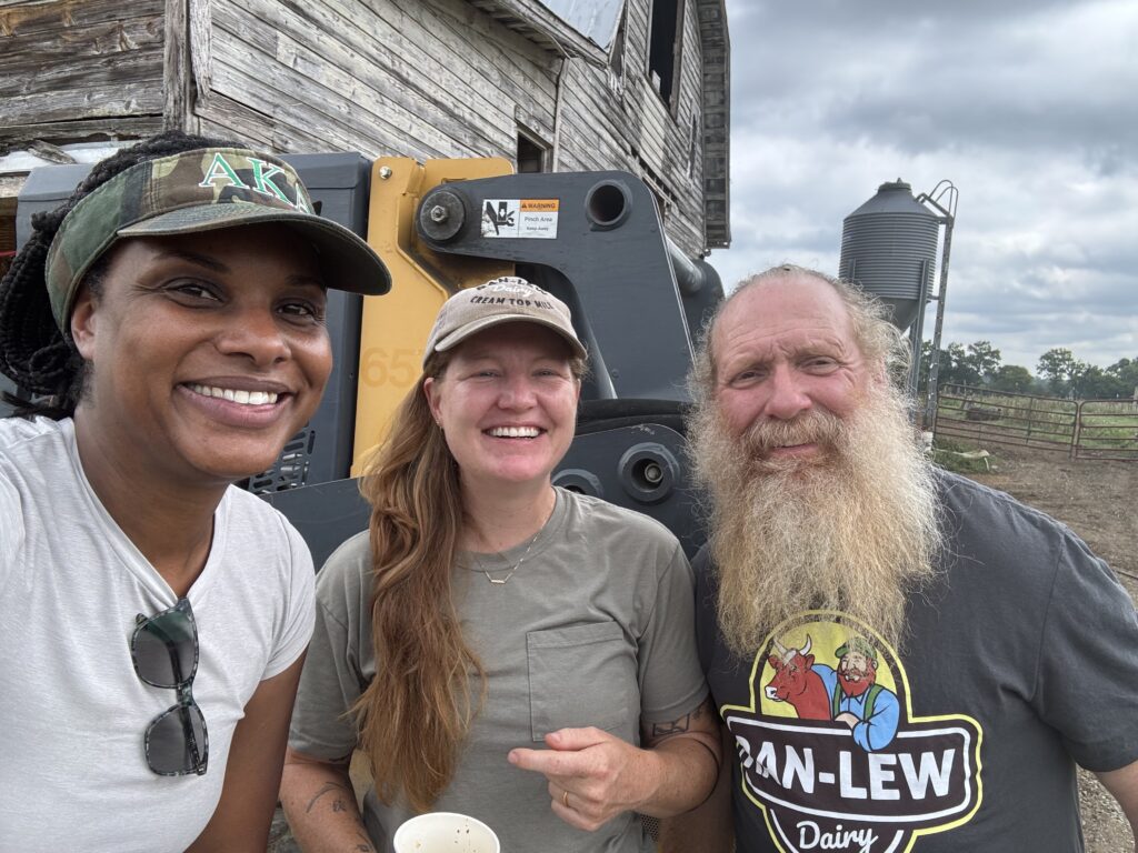 Three people smiles for the camera
