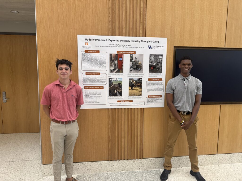 Two male students standing with their poster